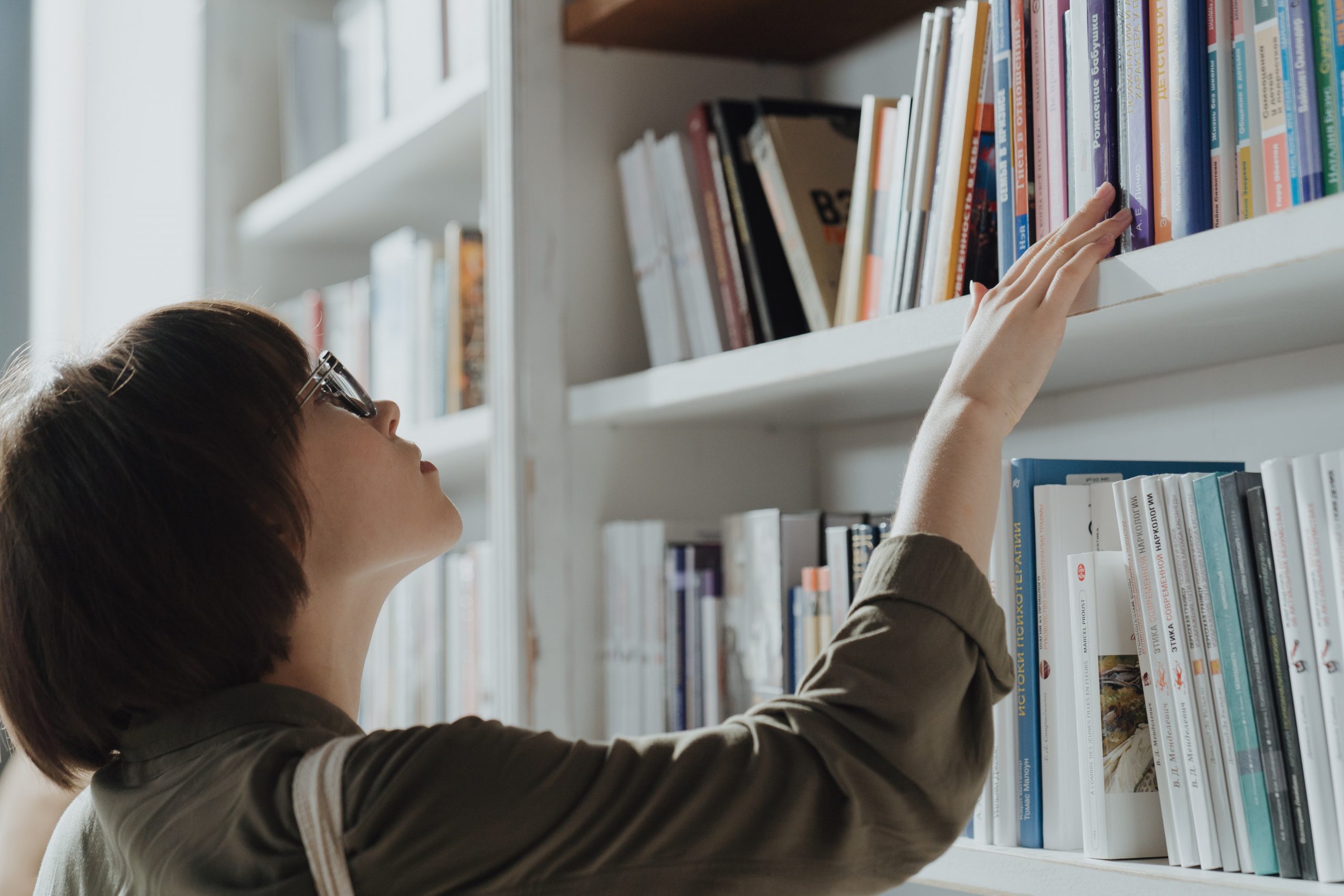 Young woman at bookstore looking at books