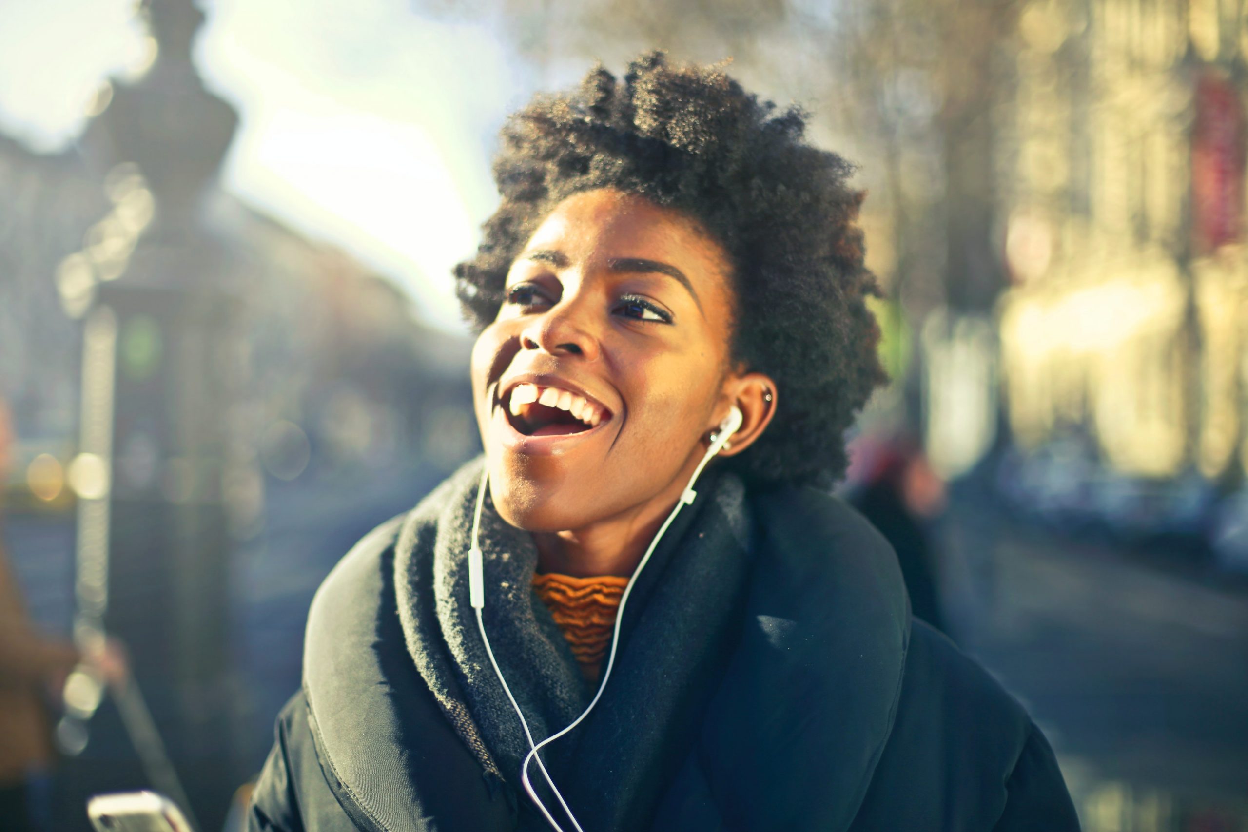 Woman listening to music through headphones and singing